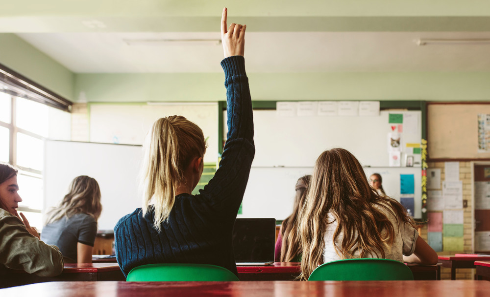 girl raises hand