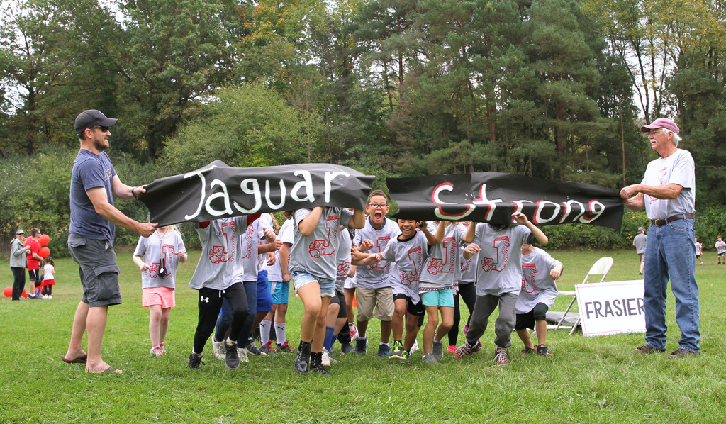 kids running through banner