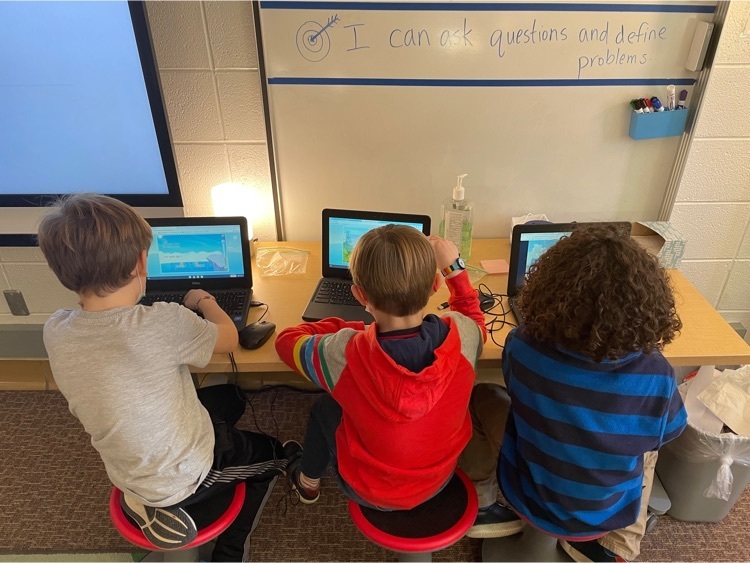 2nd grade students sitting at computers working