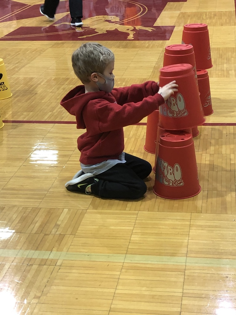student stacking giant cups