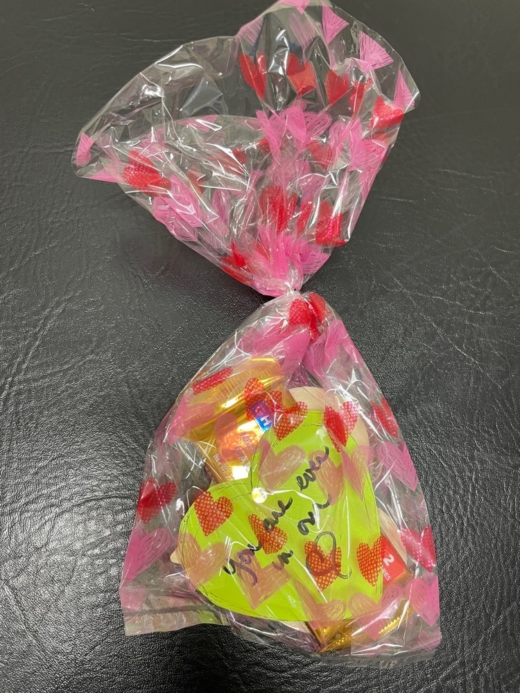 candy and note in heart bag