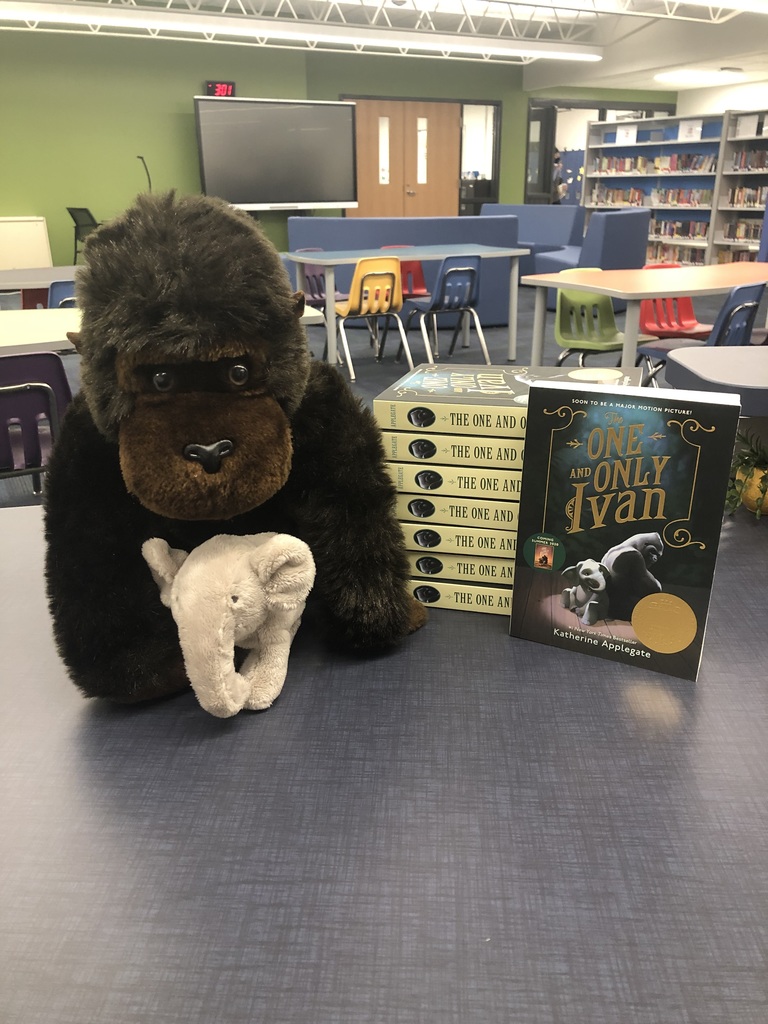 stack of books next to a stuffed gorilla and stuffed elephant