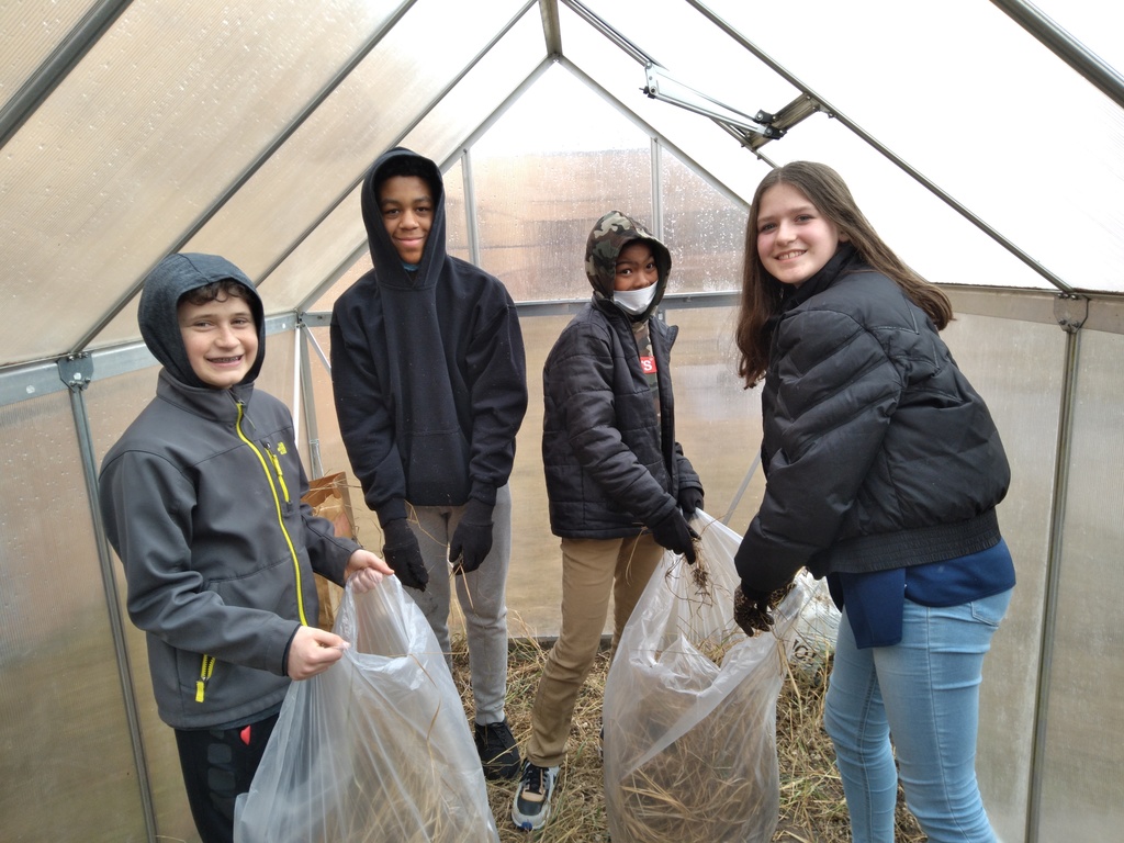 students cleaning greenhouse
