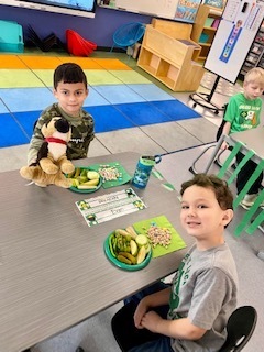 students eating green food in a classroom
