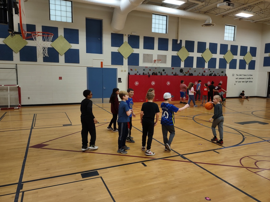 students playing basketball in gym