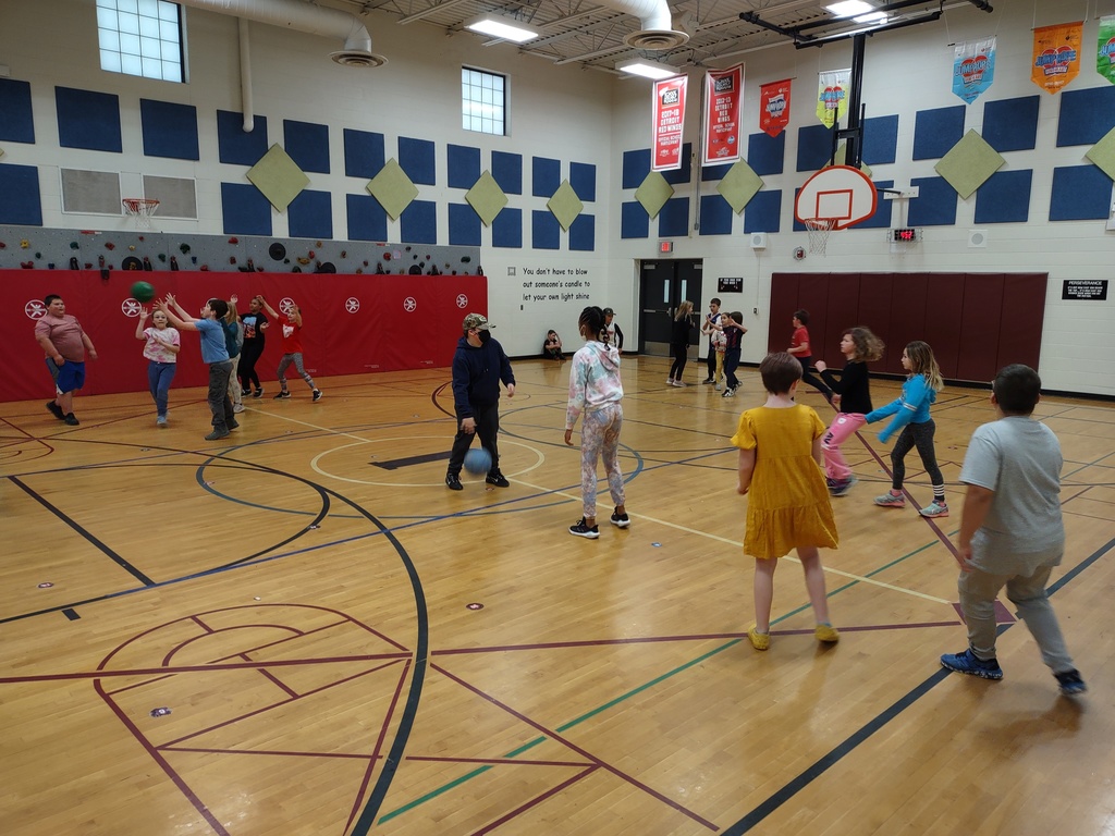 students playing basketball in gym