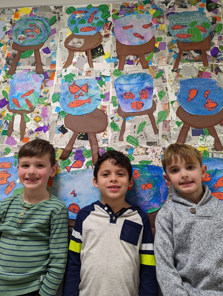 students pose with artwork