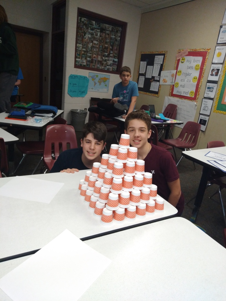 students with a pyramid of cups