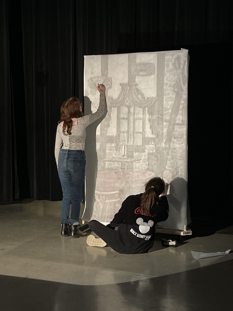 students tracing image for play backdrop