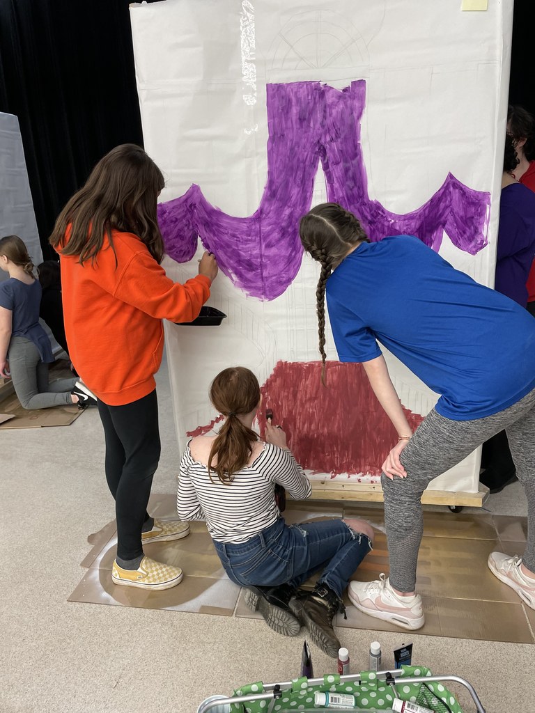 students painting backdrop