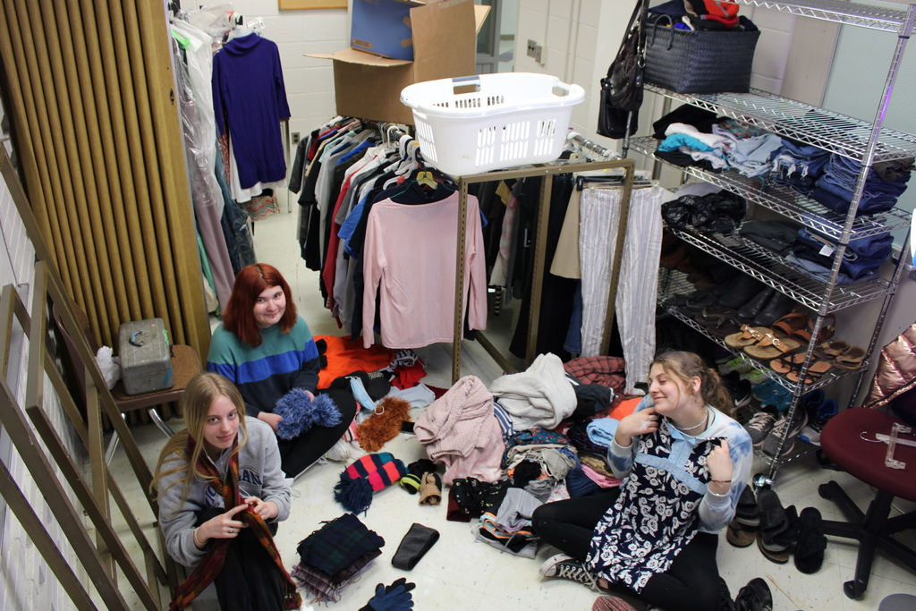girls surrounded by clothes