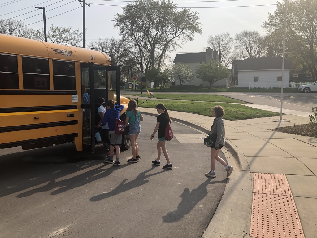 students getting on a school bus