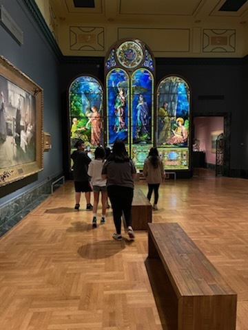 four students viewing stained glass in DIA