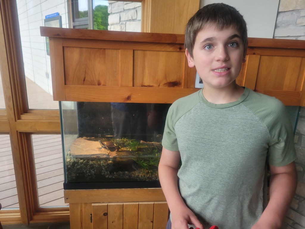 Student in front of a fish tank