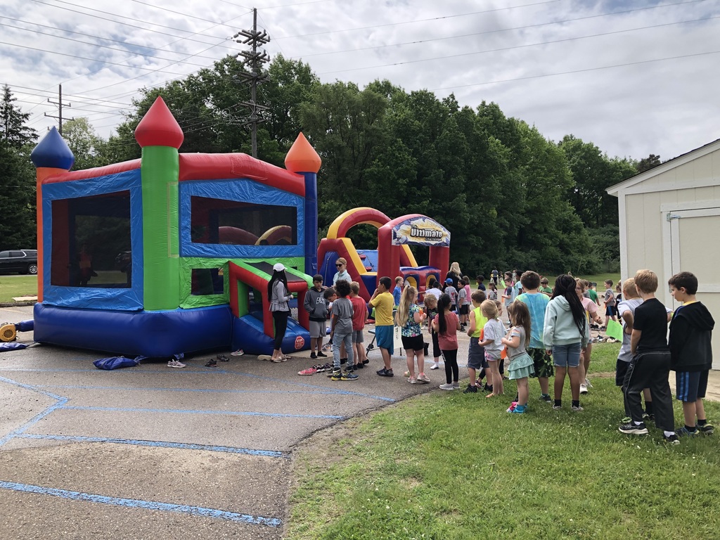 students lined up for bounce house