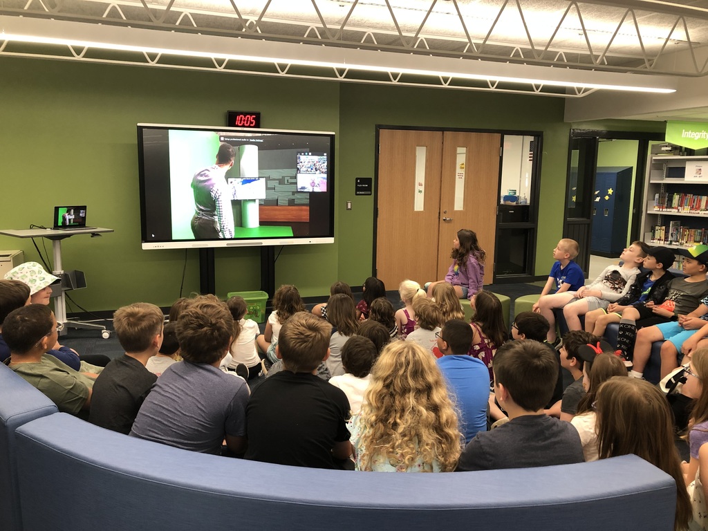 students sitting around smart board during virtual visit