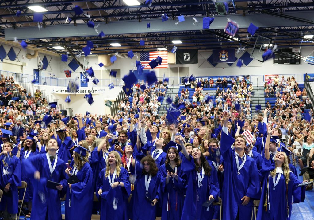 Graduates throwing caps at Lakeland 2022 graduation ceremony