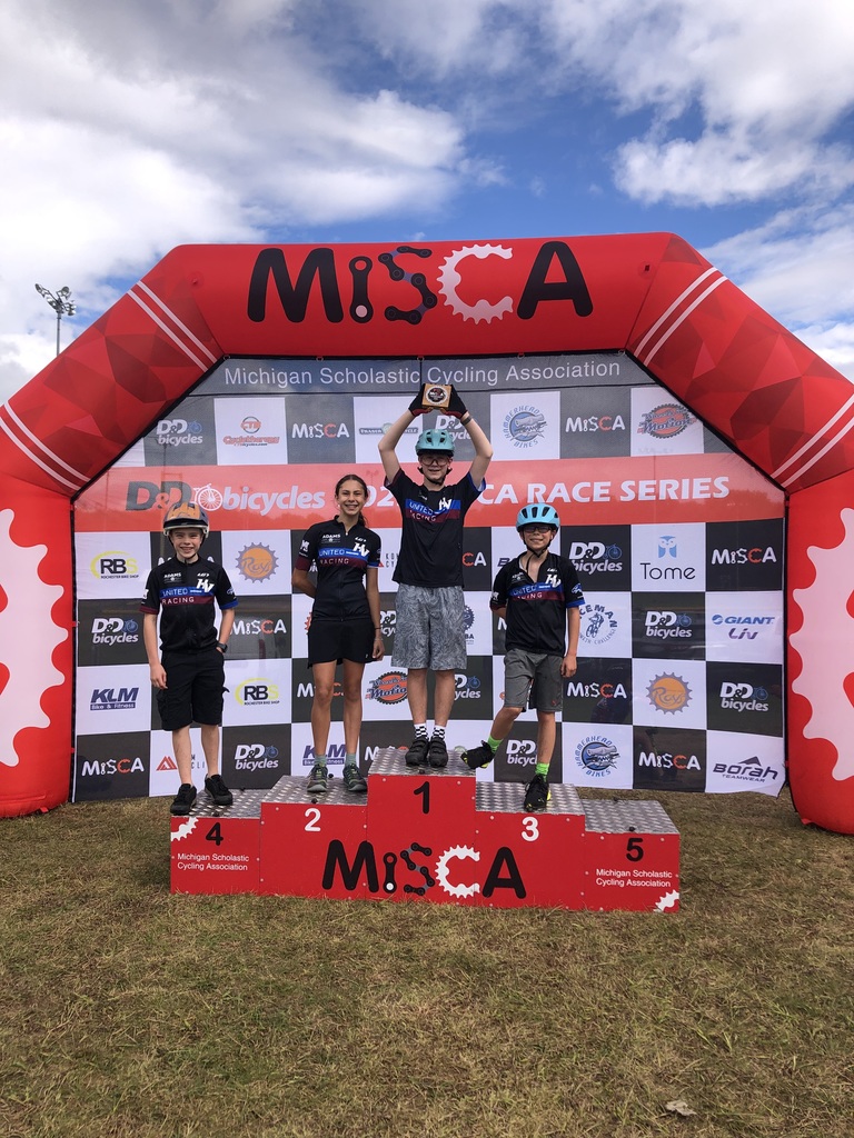 Four bicyclists on award stand