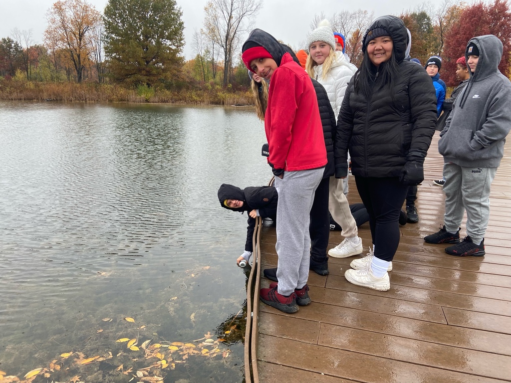 students on dock collecting water sample