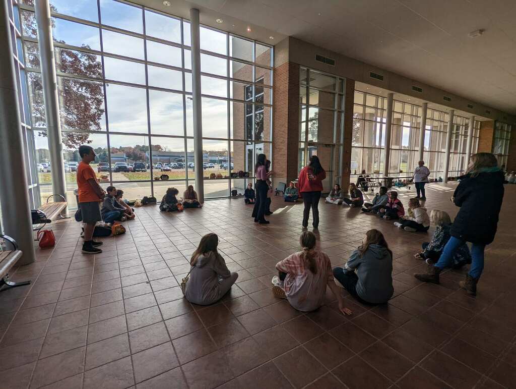 students talk in a circle in the lobby