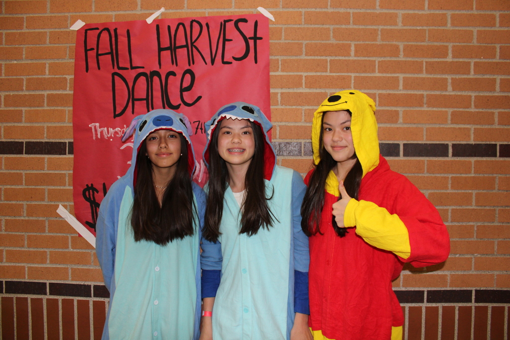 three girls in costume at the dance