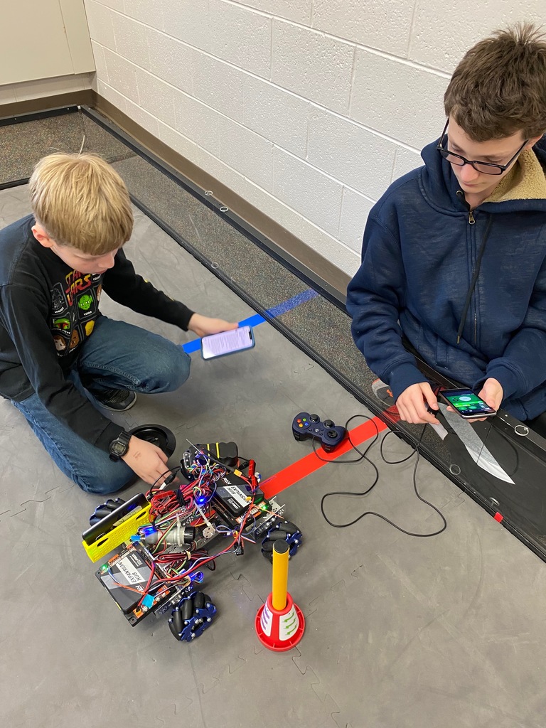 two boys working on robot construction