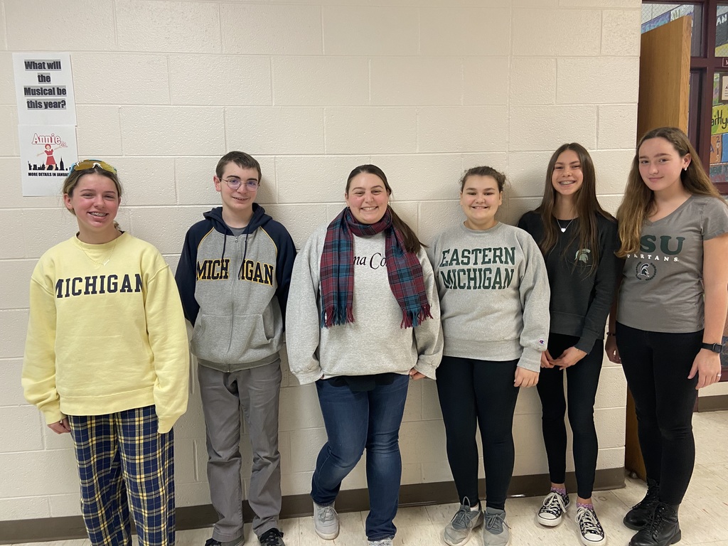 Students and teacher wearing college gear