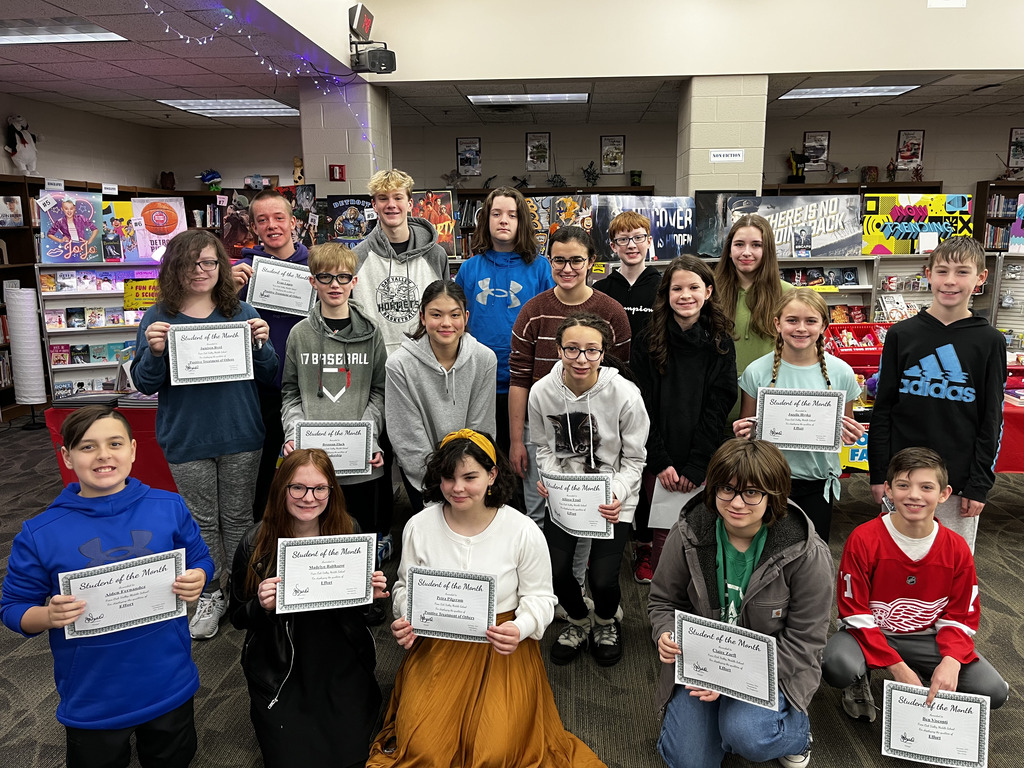 Students of the Month hold certificates