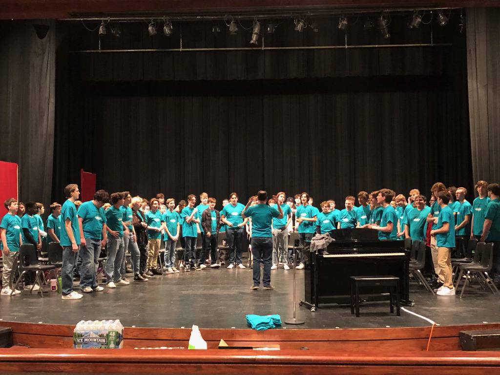 Bass Choir practices on stage