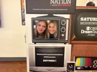two girls with faces in tv screen