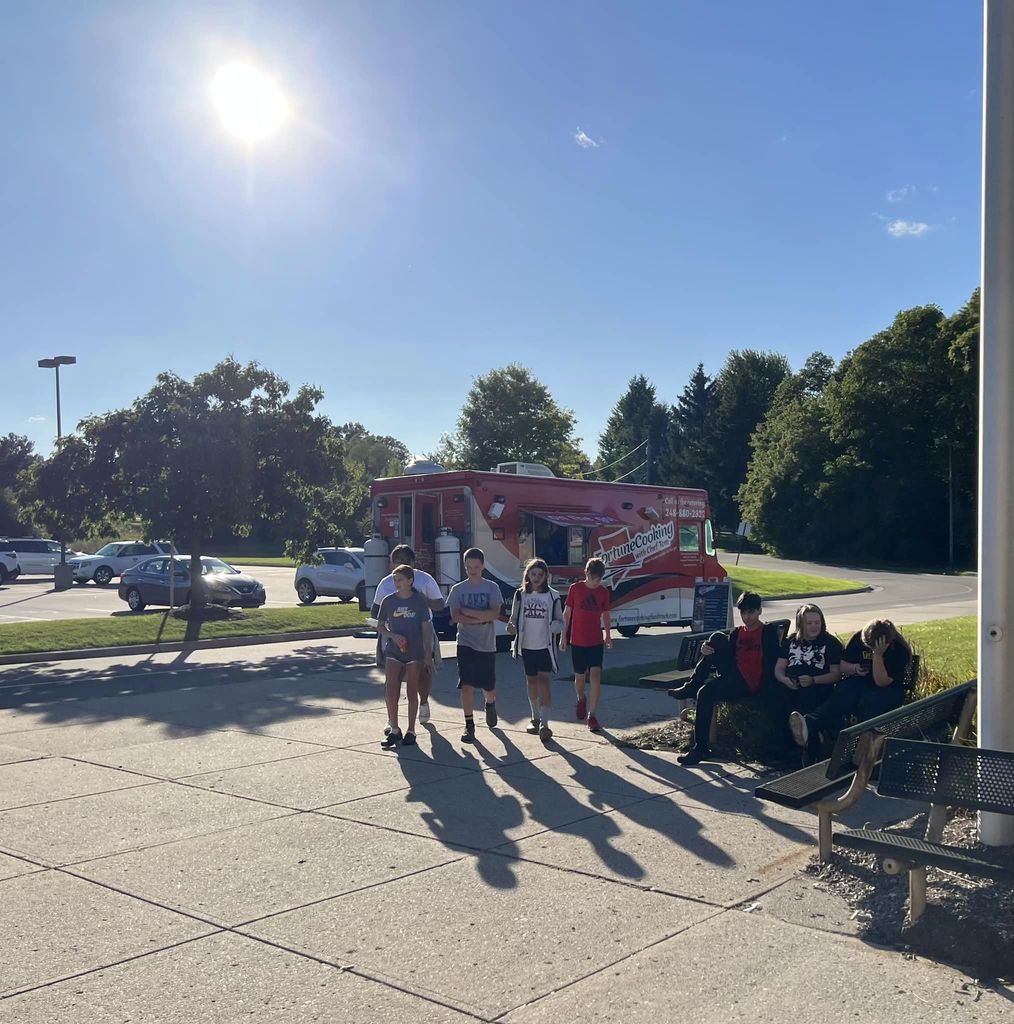 students walking by food truck